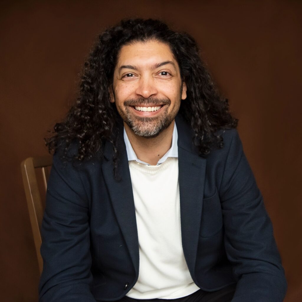 Portrait of stylish modern professional multiracial man on brown background.